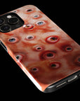 Eyesore Monster Flesh phone case!  For iPhone, Samsung Galaxy, and Google Pixel devices.  Muhahaha! presents the perfect spooky, Halloween gift.  Every case has double layers for extra durability and protection while the clear, open ports stay out of your way when it comes to charging. Choose between matte or glossy finish. (pictured: iPhone 15 pro rocking an Eyesore Monster Flesh phone case)