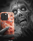 A zombie takes a selfie with an Eyesore Monster Flesh phone case!  Available for iPhone, Samsung Galaxy, and Google Pixel devices.  Muhahaha! presents the perfect spooky, Halloween gift.  Every case has double layers for extra durability and protection while the clear, open ports stay out of your way when it comes to charging. Choose between matte or glossy finish. (pictured: iPhone 15 pro with an Eyesore Monster Flesh phone case)