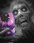 A zombie takes a selfie with a Kraken Monster Flesh phone case!  Available for iPhone, Samsung Galaxy, and Google Pixel devices.  Muhahaha! presents the perfect spooky, Halloween gift.  Every case has double layers for extra durability and protection while the clear, open ports stay out of your way when it comes to charging. Choose between matte or glossy finish. (pictured: iPhone 15 pro with a Kraken Monster Flesh phone case)