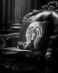 Skeleton Peekaboo pillow by Muahaha!  Black and white photo of the 16x16 faux suede pillow showing a skeleton's face resting on an antique arm chair in a victorian mansion.  The perfect Halloween gift!