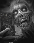 A zombie takes a selfie with a Wraith Monster Flesh phone case!  Available for iPhone, Samsung Galaxy, and Google Pixel devices.  Muhahaha! presents the perfect spooky, Halloween gift.  Every case has double layers for extra durability and protection while the clear, open ports stay out of your way when it comes to charging. Choose between matte or glossy finish. (pictured: iPhone 15 pro with a Wraith Monster Flesh phone case)
