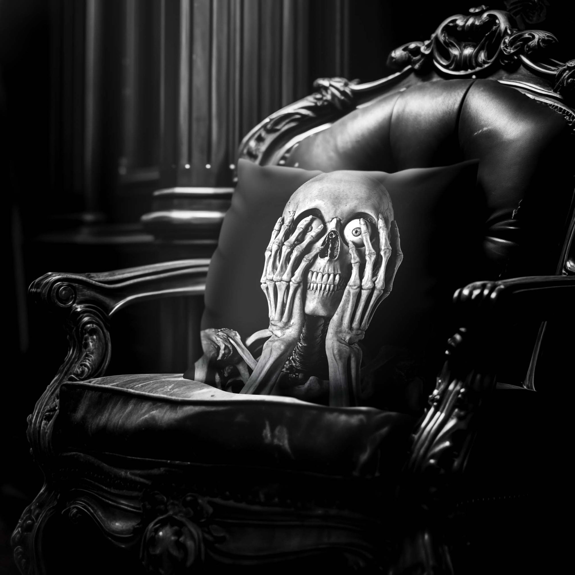 Skeleton Peekaboo pillow by Muahaha!  Black and white photo of the 16x16 faux suede pillow showing a skeleton's face resting on an antique arm chair in a victorian mansion.  The perfect Halloween gift!